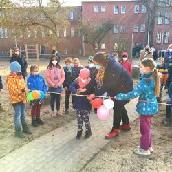 Kinder Schneiden ein Band durch